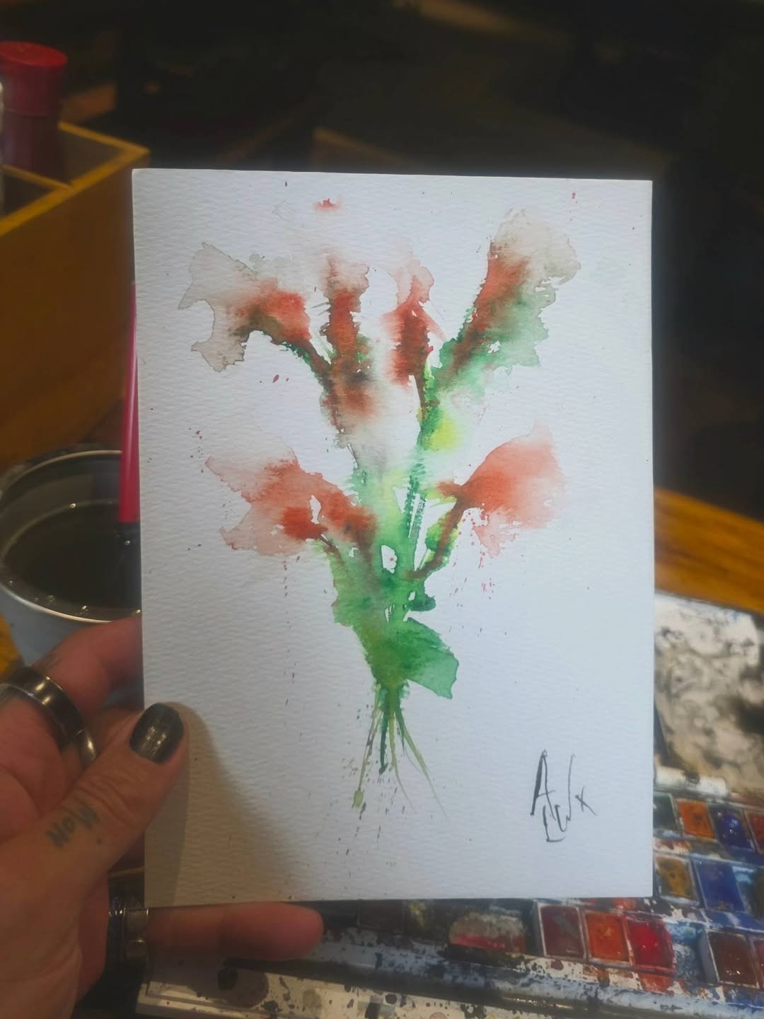 Watercolour study of a warm-toned orange and green wildflower bouquet