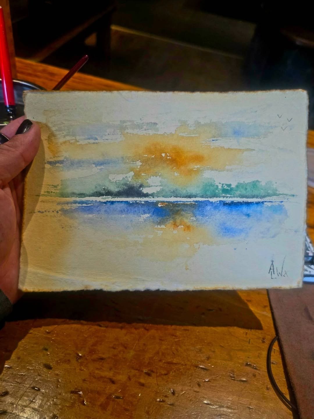 Loose sketch of a loch at sunset, orange sky over blue water
