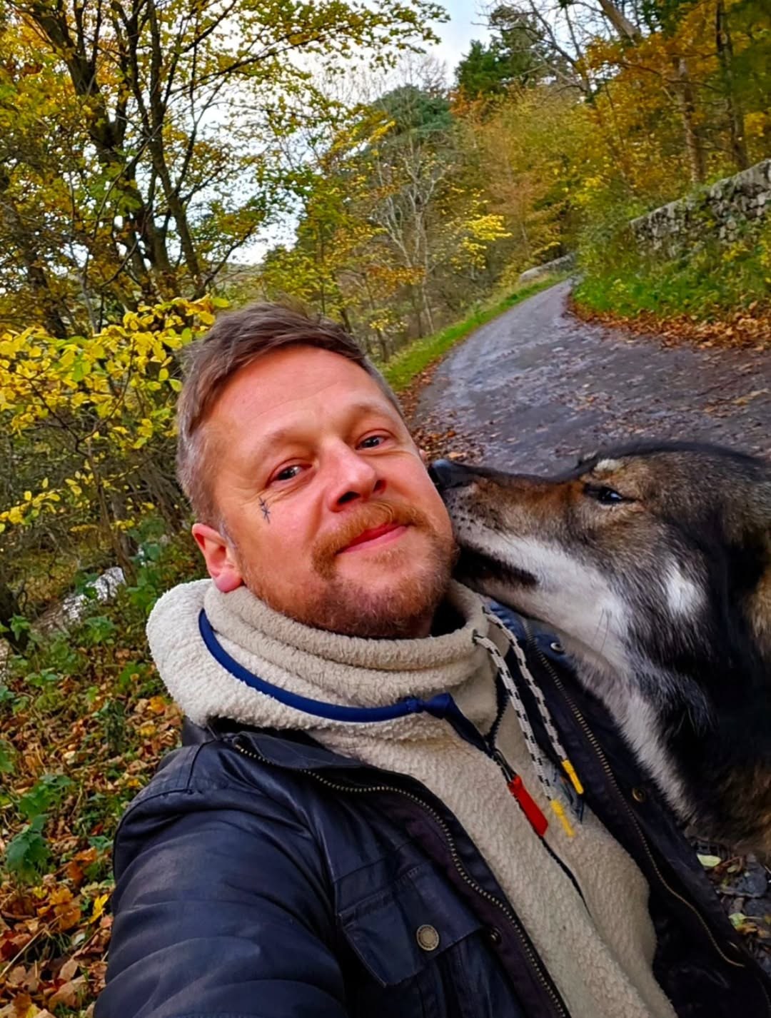 The artist with North, his wolfdog, at home